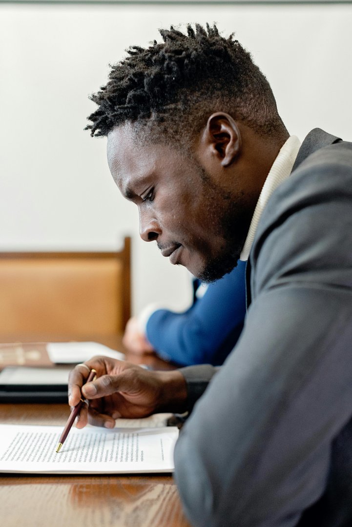 Carlos reviewing and signing a document
