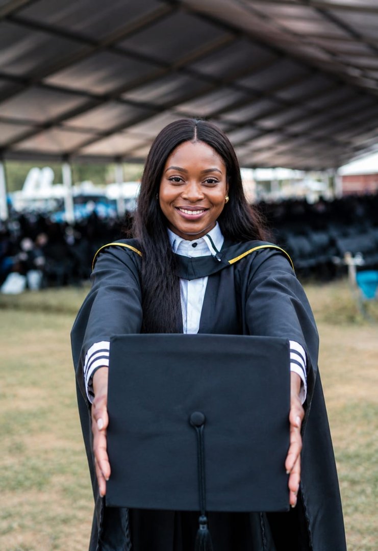 Smiling graduate holding her cap